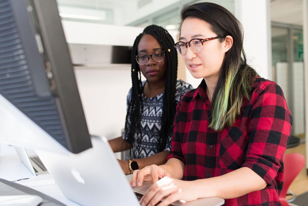 Two women looking at a laptop